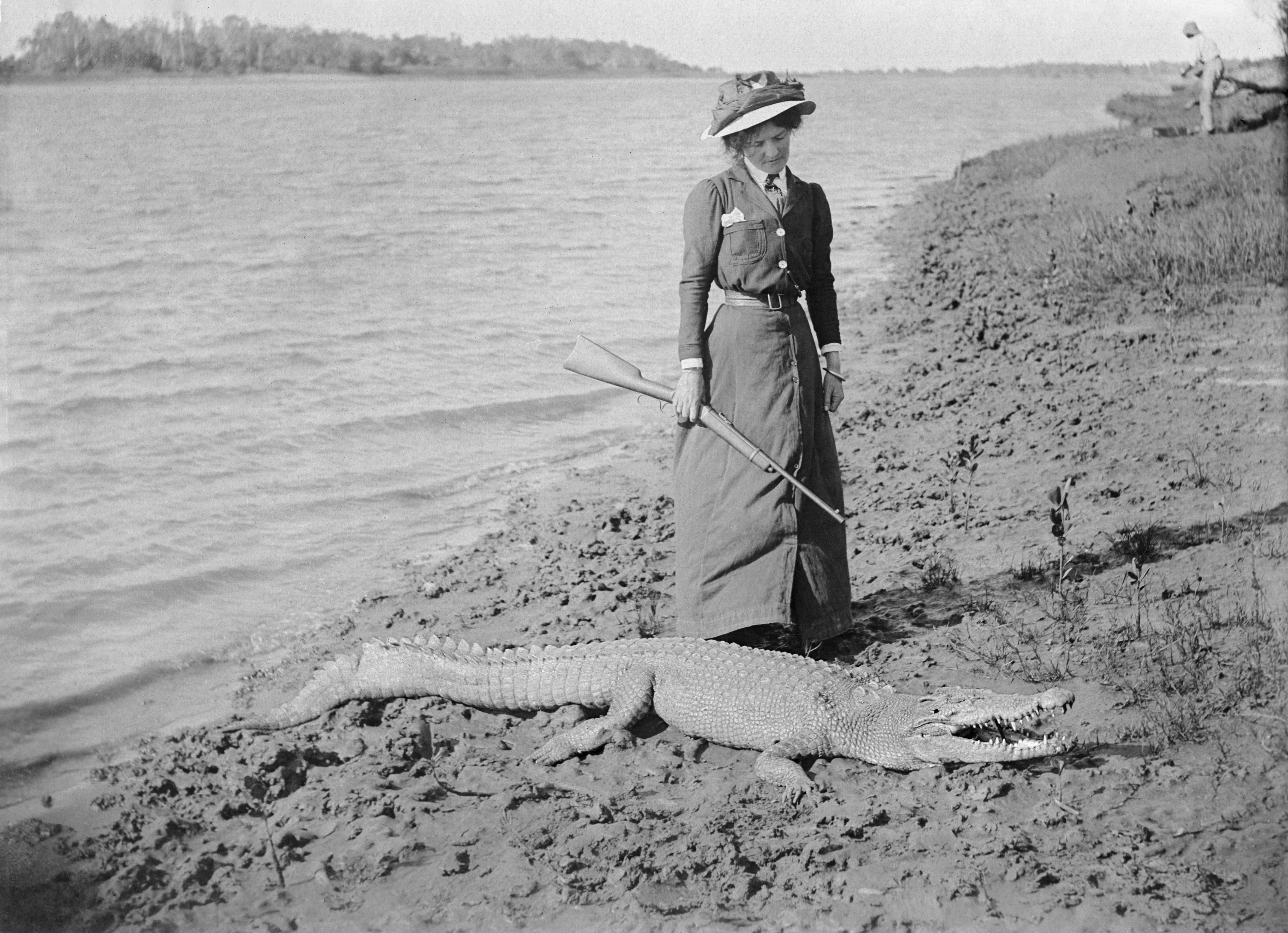 L'Estrange, Robert Augustus Henry (ca. 1910) Unknown lady with rifle and a saltwater crocodile. 
https://digitalcollections.qut.edu.au/4506/